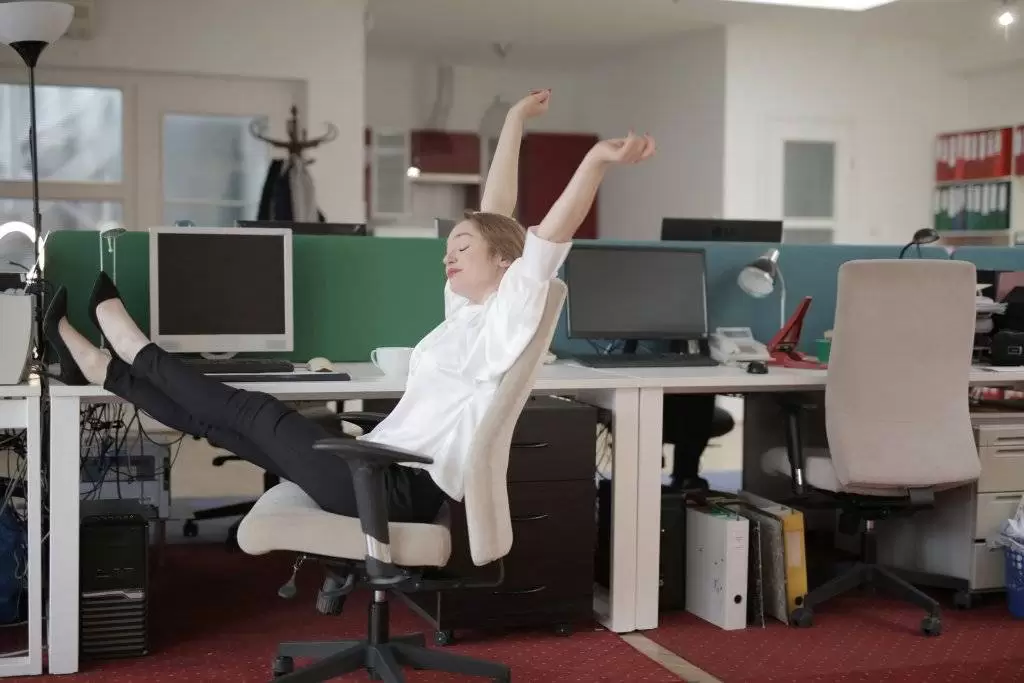 Woman stretching on office chair